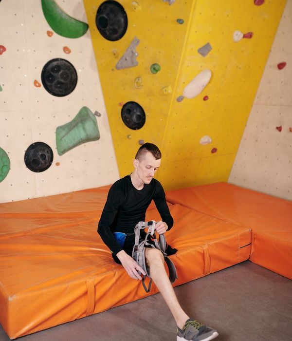 Man performing a controlled strength exercise in a modern gym setting.